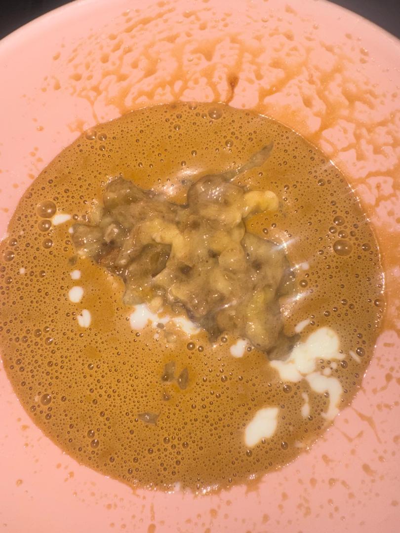 Wet ingredients with mashed bananas and buttermilk in a pink bowl