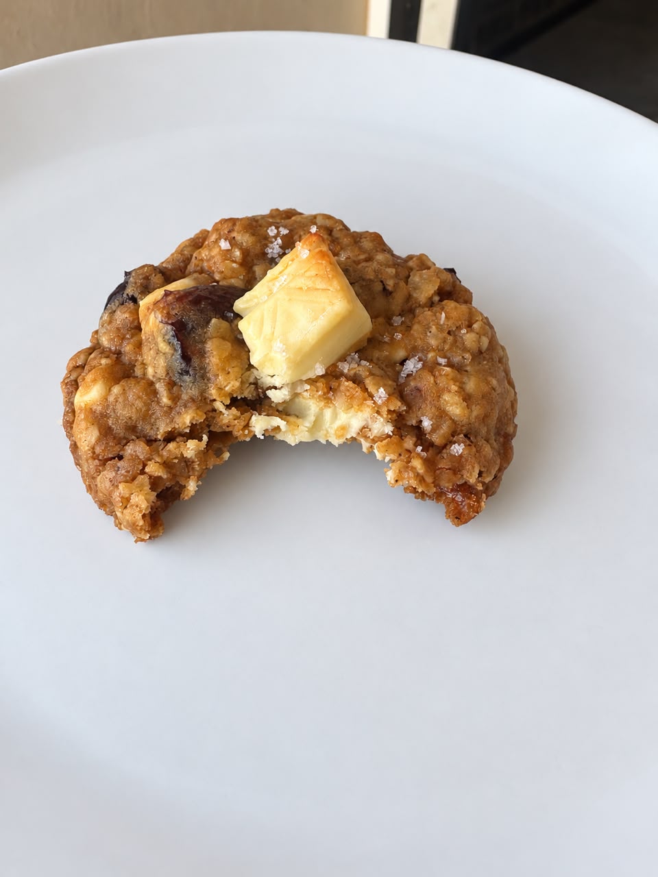 White chocolate cranberry cookie with a bite taken out